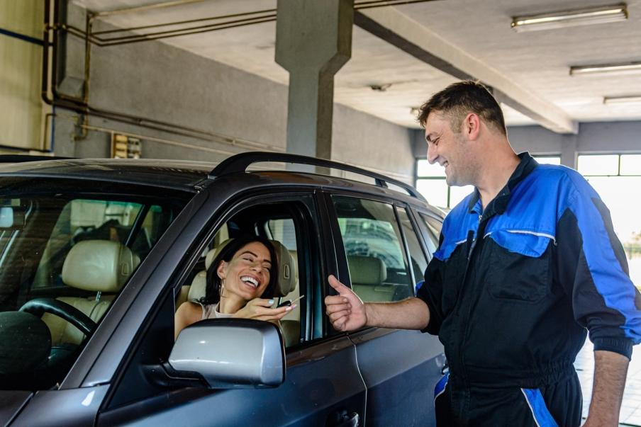 A driver and a local garage mechanic shaking hands